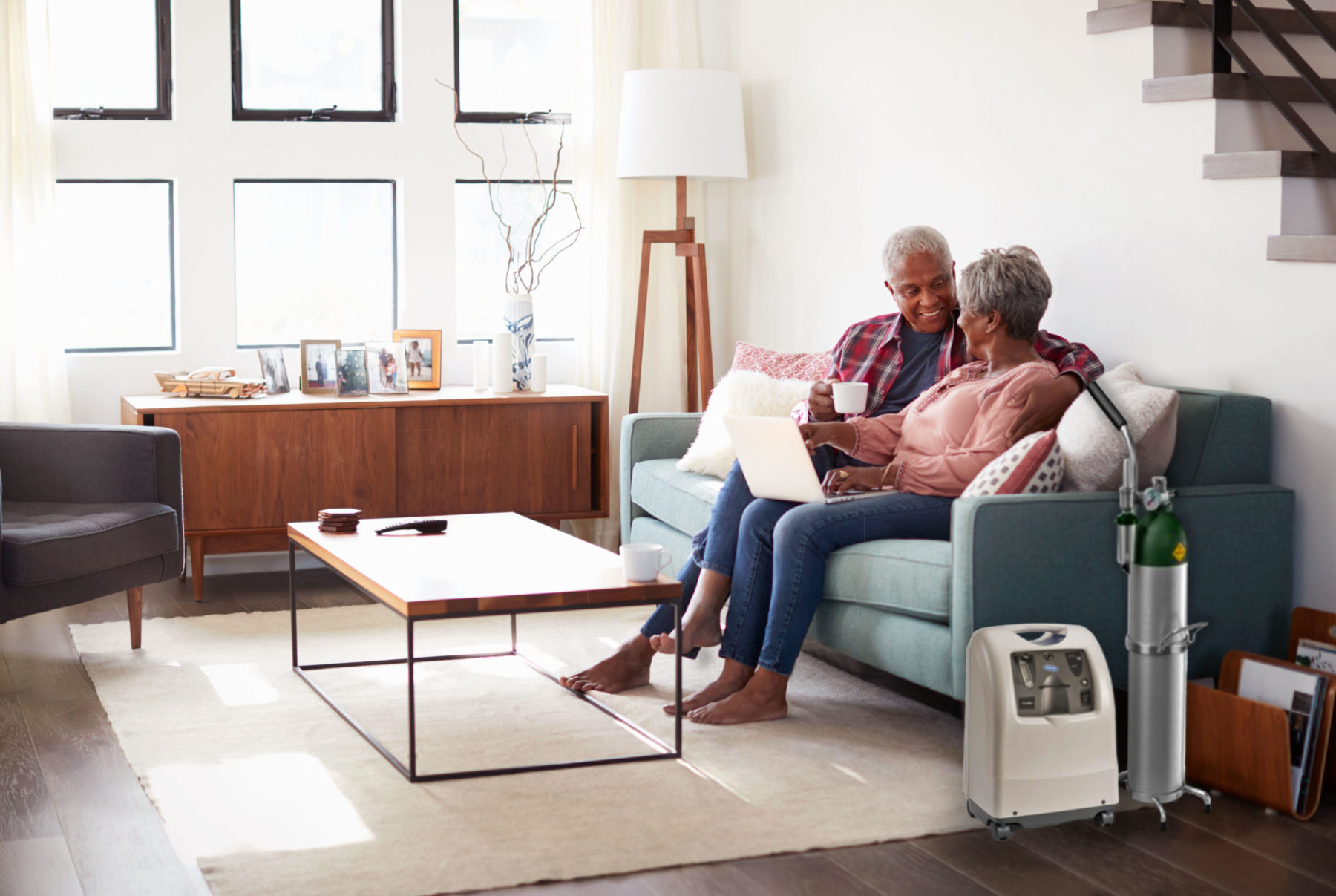 A couple enjoying each other's company on their couch while using an oxygen compressor.