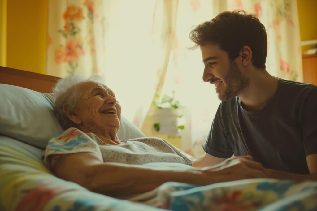 A grandson visiting with his grandmother in a hospital bed.